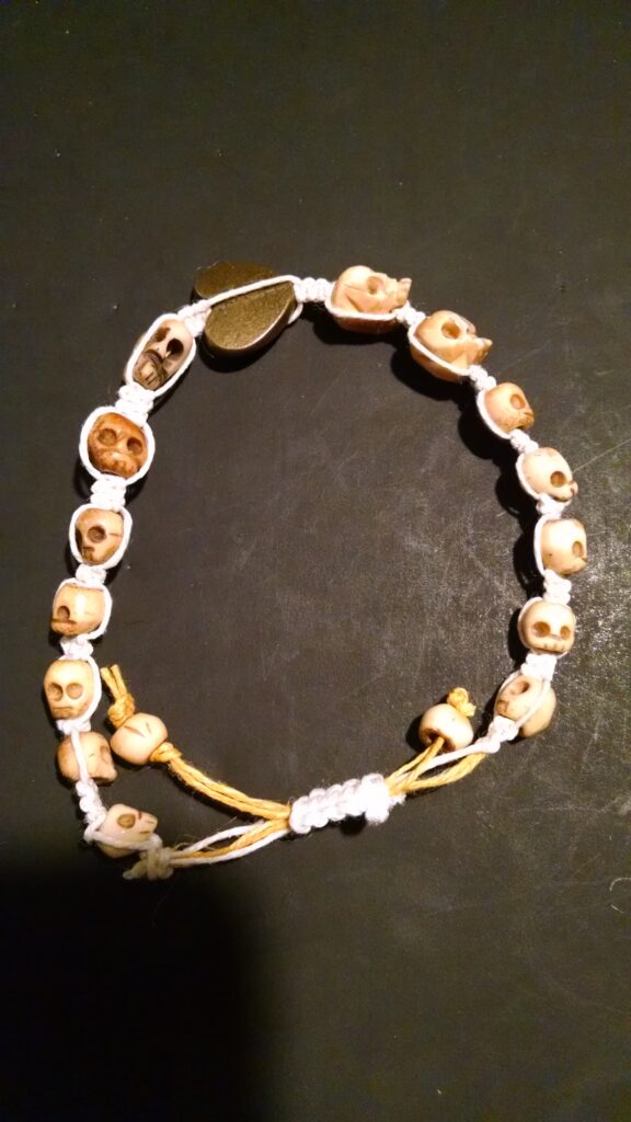 Skull beads with bronze colored heart.