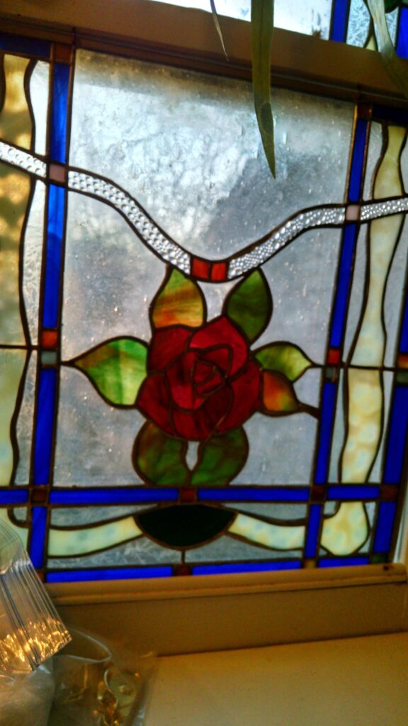 Stained glass art nuevo rose for the bathroom window