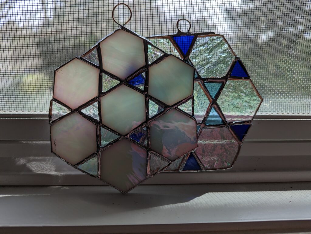 Stained glass playing with snow flake patterns from a microscopic snowflake book.