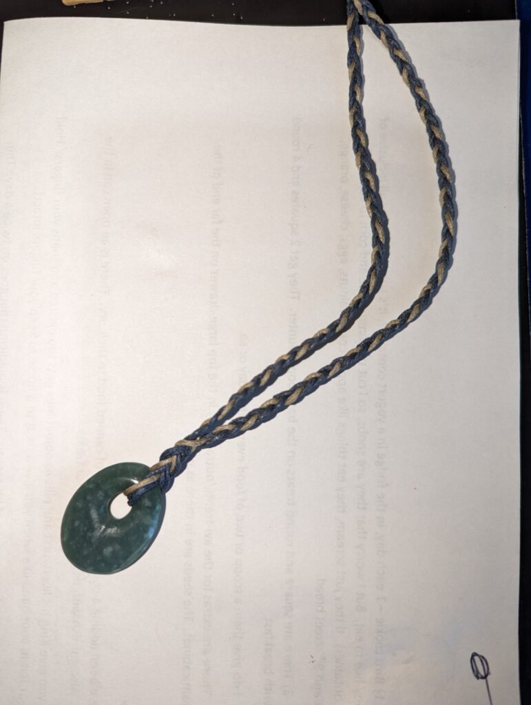 Jade pendant with four strand braid